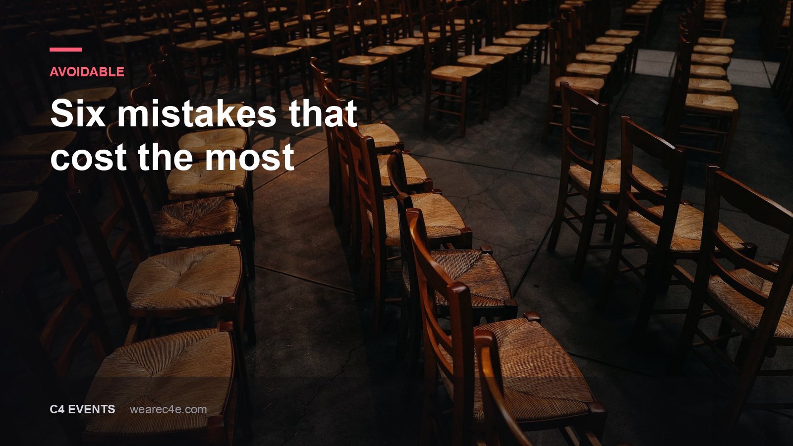 Rows of empty chairs in a dim hall before an event.